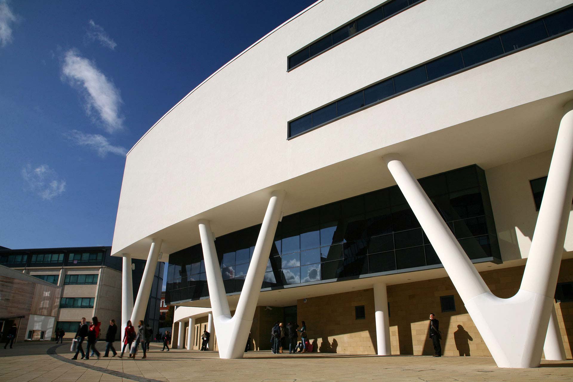 Alternate View of the white Creative Arts Building in the sunshine on campus