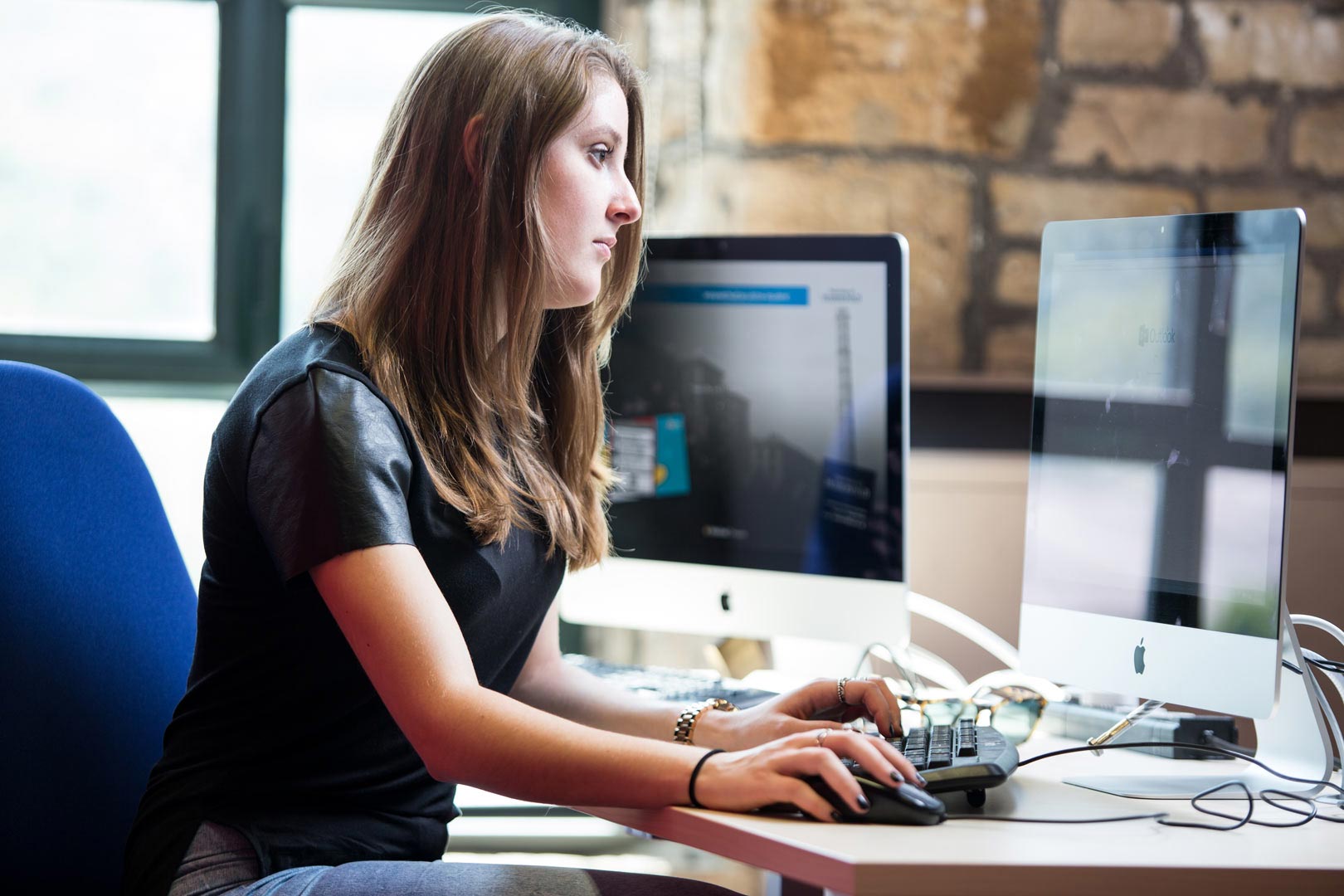 Female student working in a computing laboratory in the School of Computing and Engineering