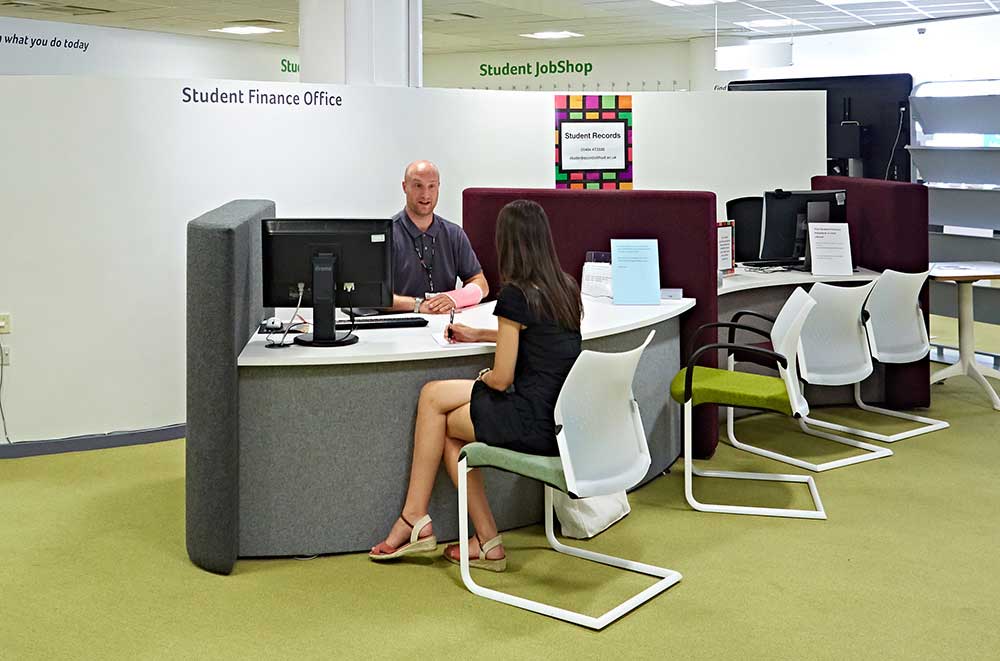 A student receiving support at the student finance desk