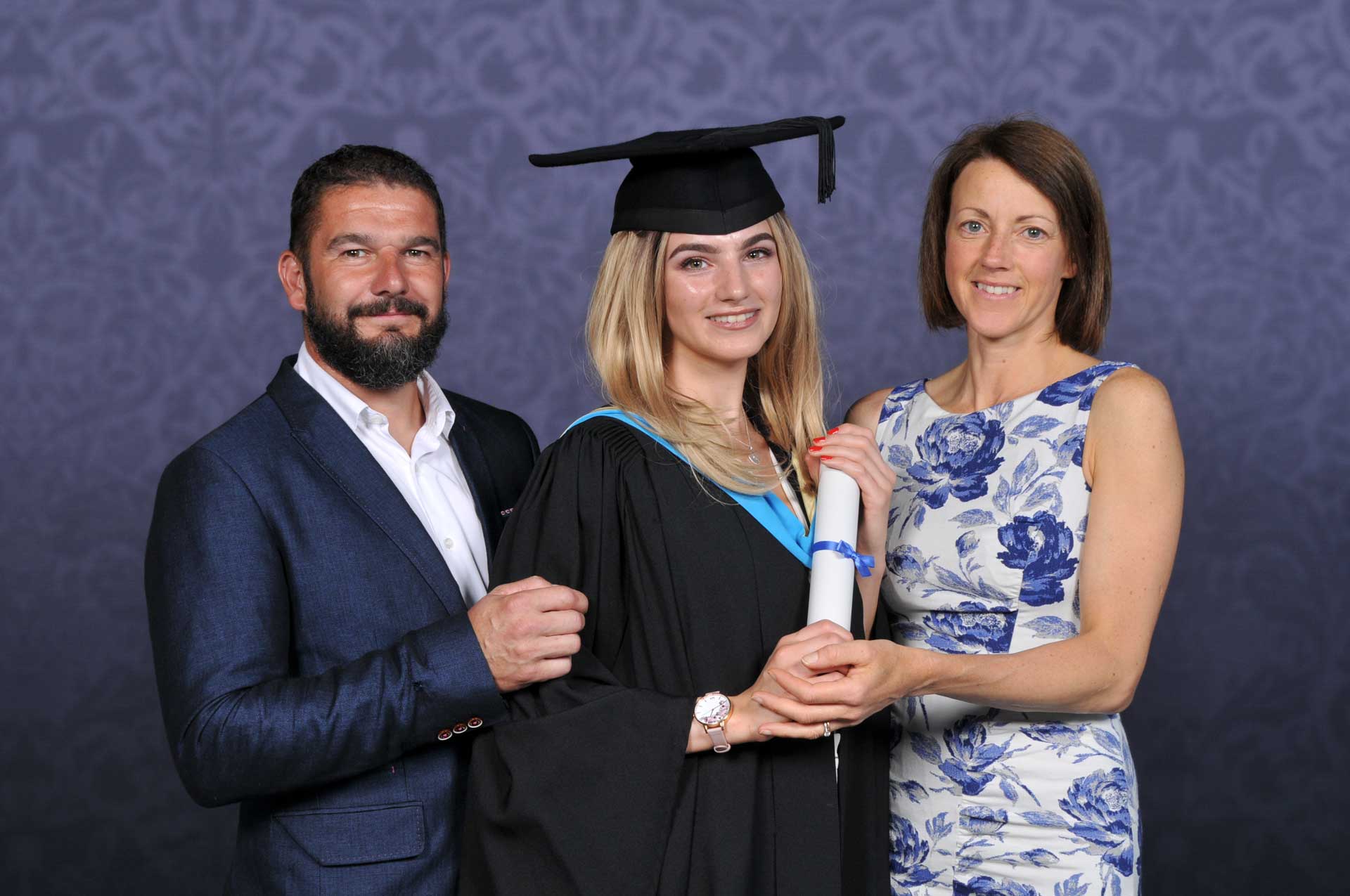 Photo of a family at graduation taken by Tempest with professional backdrop