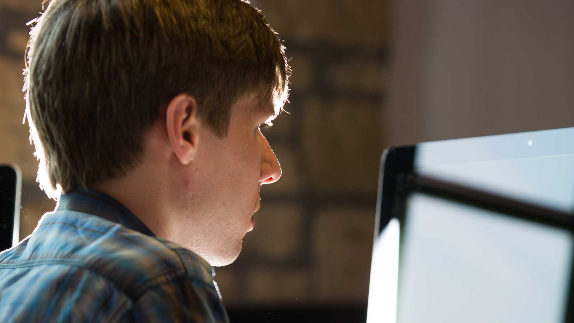 Picture from behind a student who is looking at a computer screen